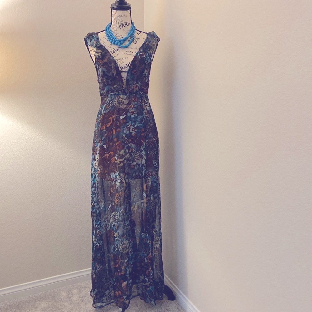 Small sheer maxi dress with cross cross open back. Side slit up to mid thigh.